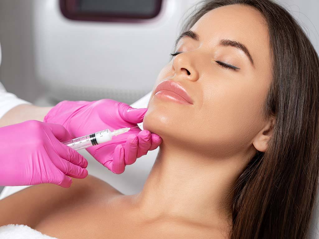 Plastic surgeon injects Kybella injection non-surgical liposuction, Honolulu, Oahu.