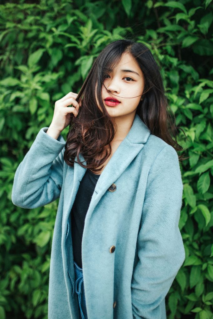 woman standing outdoors after her rhinoplasty surgery