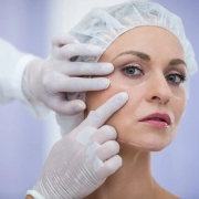 A female patient with surgical markings on her face during a facelift consultation with a Hawaii facial plastic surgeon.