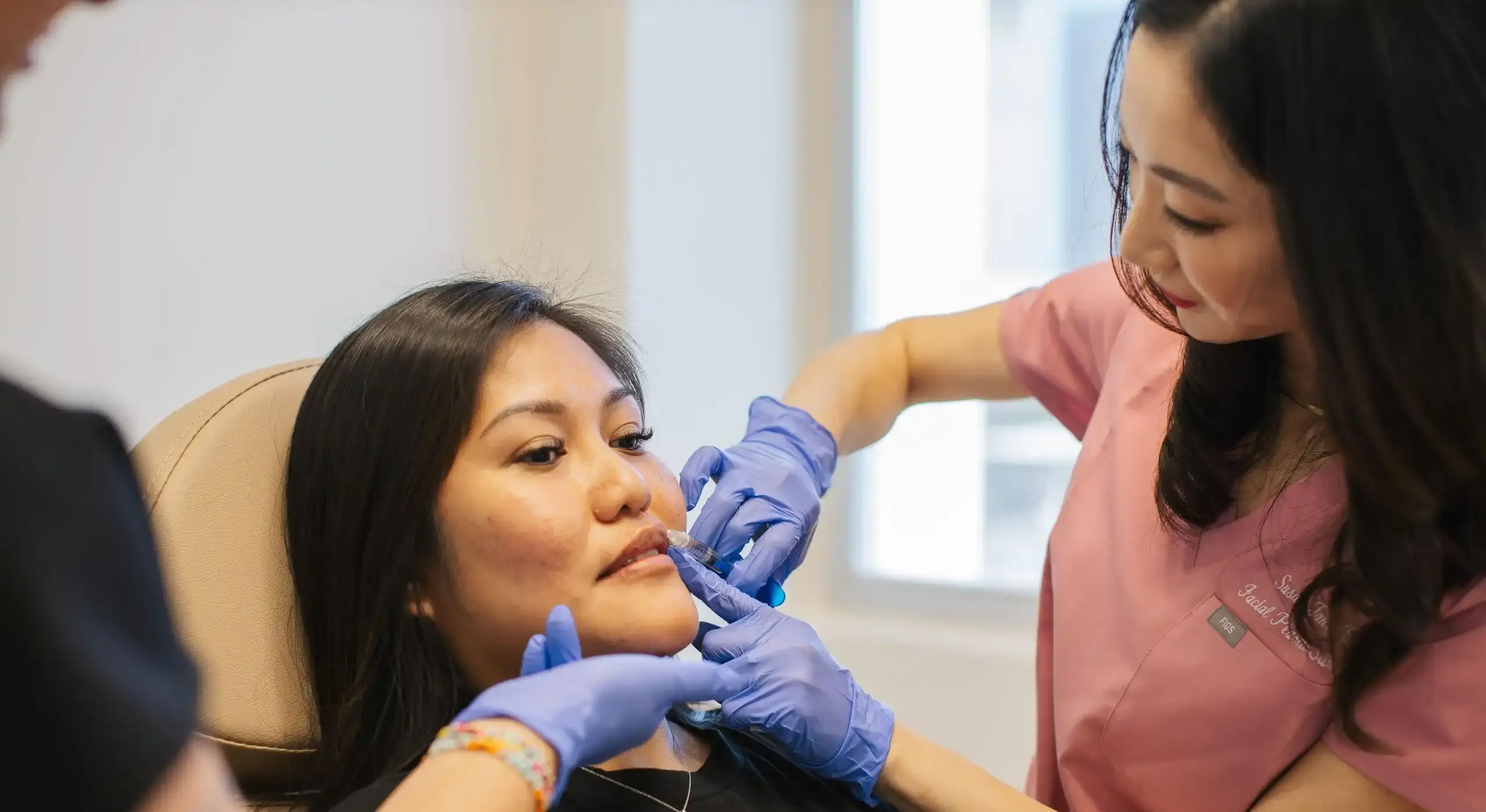 Dr Susan Tan injects dermal fillers as part of a non-surgical facial treatment to increase lip volume.